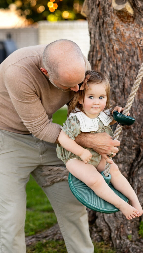 Father helping daughter on a swing, reflecting balance and support in what is scaling your business.