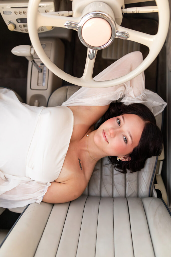 Emma Laying in the Pink Figgy car