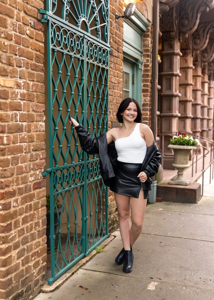 A young woman poses for Downtown Senior Pictures Charleston SC 
