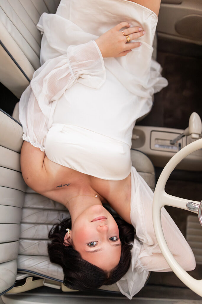 During senior pictures in Charleston SC, a young woman poses in The PInk Figgy