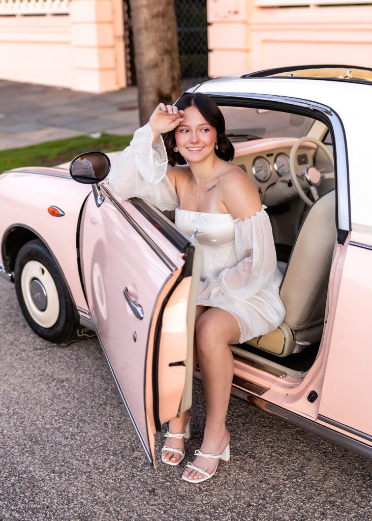Senior pictures in Charleston SC featuring the Pink Figgy on Rainbow Row