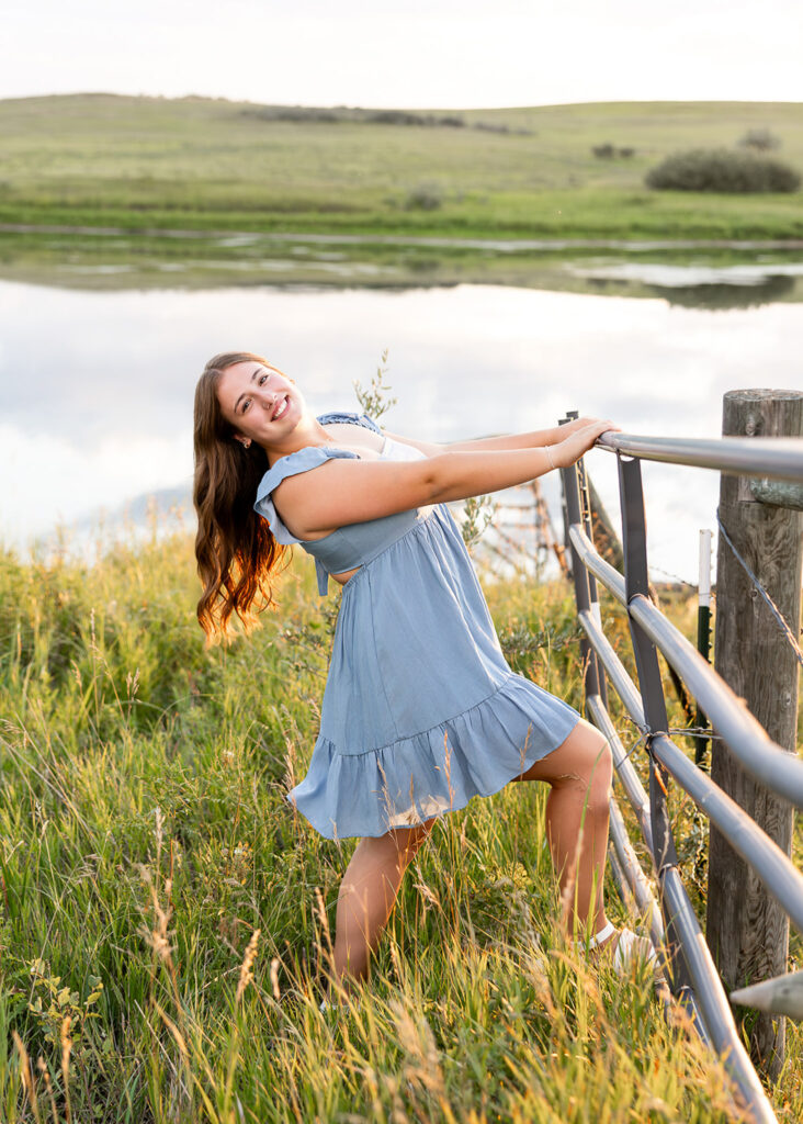 Addison Hansen surrounded by wildflowers during a calm senior evening