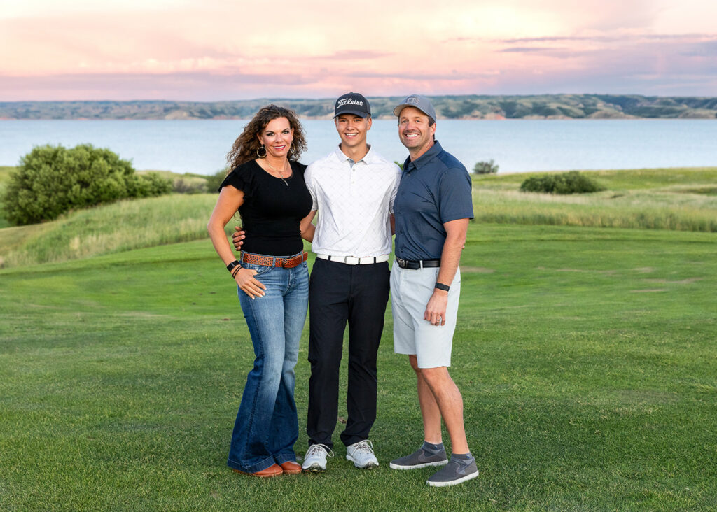 Evan Fisher senior pictures downtown in Williston on a windy evening
