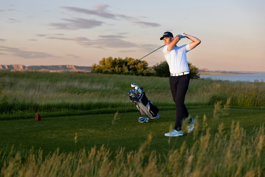 Evan Fisher senior pictures downtown in Williston on a windy evening