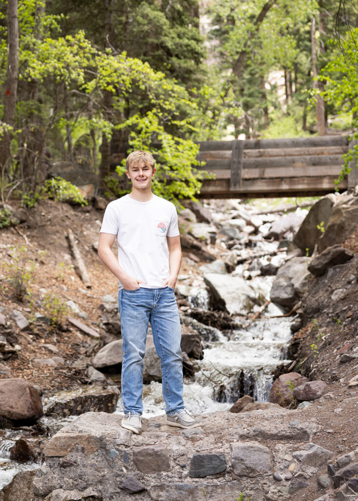 A young man poses for a high school senior portrait in Colorado featured in a blog about senior trip ideas 