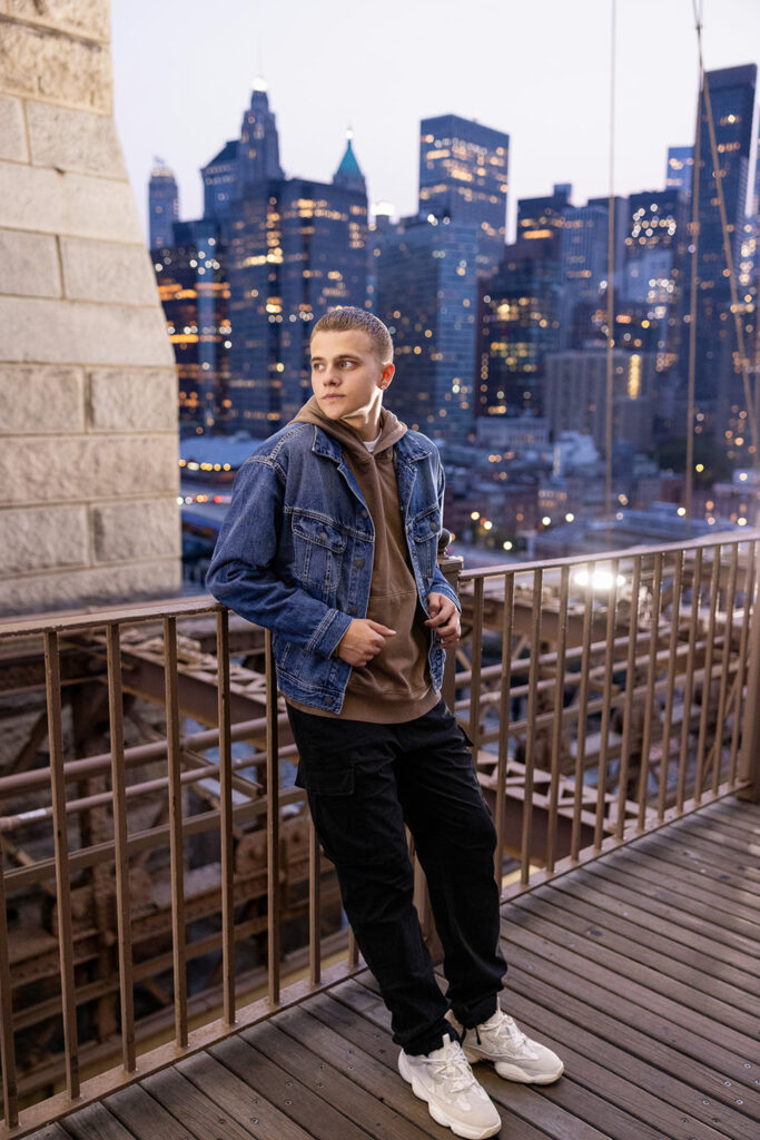 Senior boy on the Brooklyn Bridge at dusk for senior photos