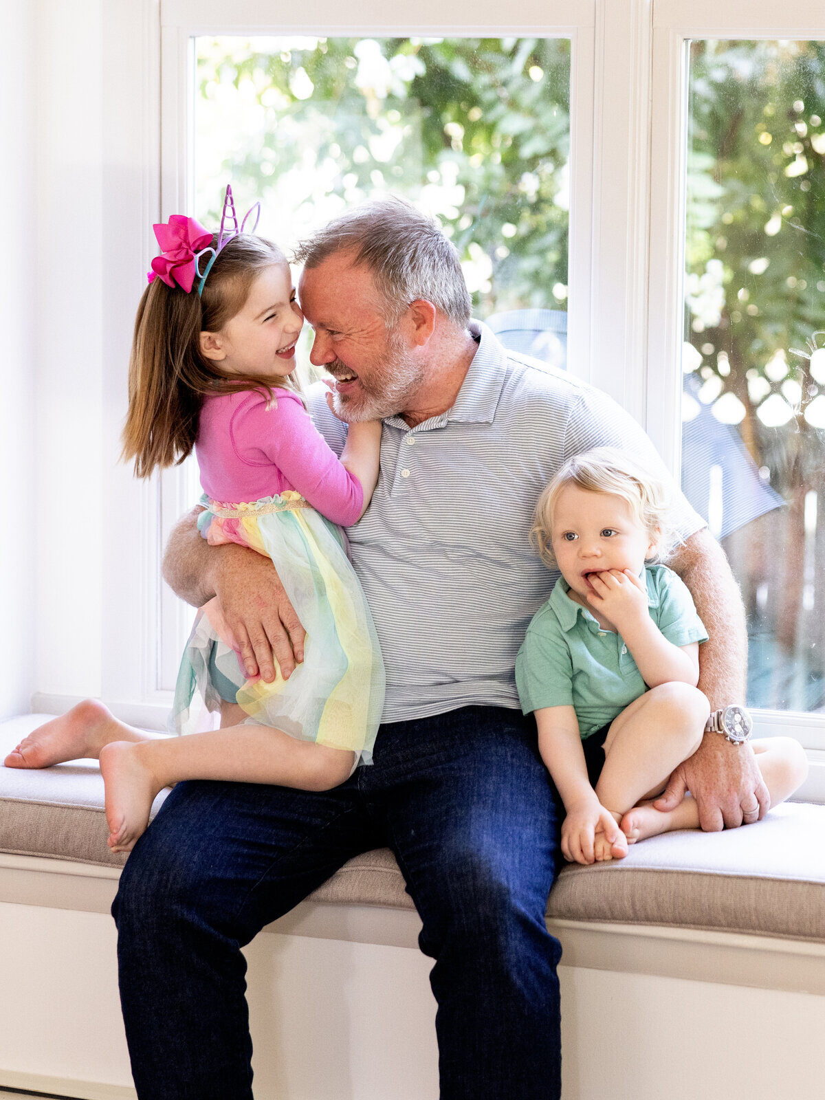 photography-tips-for-beginners A joyful moment between a grandfather and his grandkids, full of laughter, light, and genuine connection.