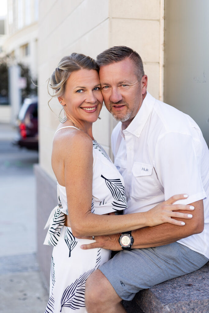 A married couple is shown embracing for couples photography in nashville