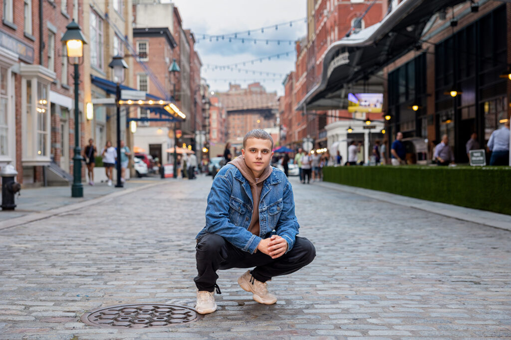 A senior boy poses during a nyc senior trip