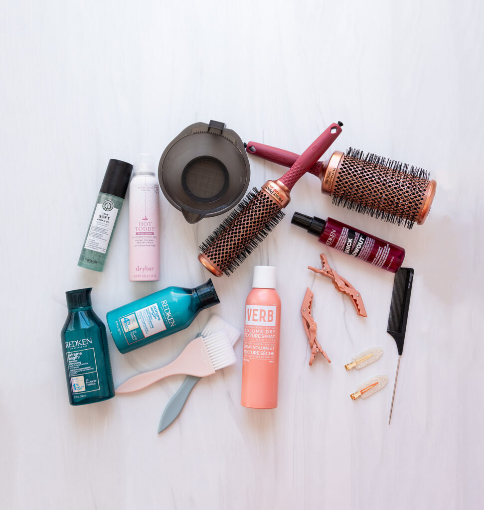 Flat lay of ND cosmetology tools including shears, combs, brushes, and hot tools for branding session