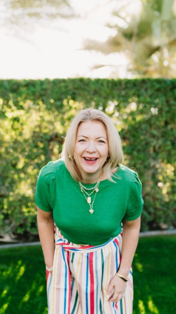 Smiling photographer leaning forward outdoors during branding session while discussing Aftershoot AI culling workflow for photographers.