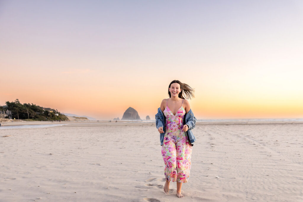 Senior girl running on the beach at Cannonball beach at sunset
