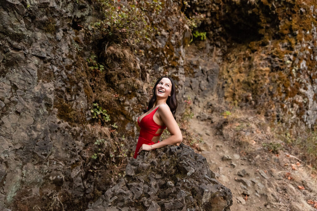 Senior girl in red dress at Multnomah Falls Oregon