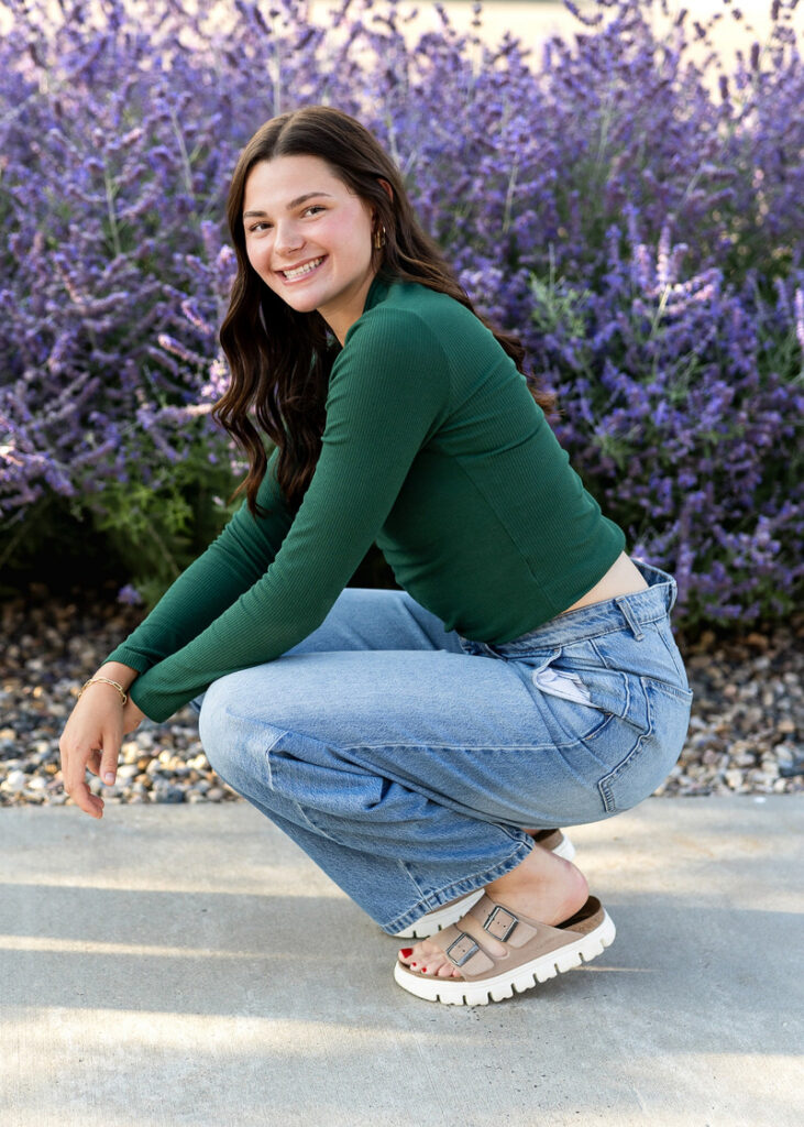 Senior smiling in purple flowers, natural portrait helping clients feel comfortable in front of the camera