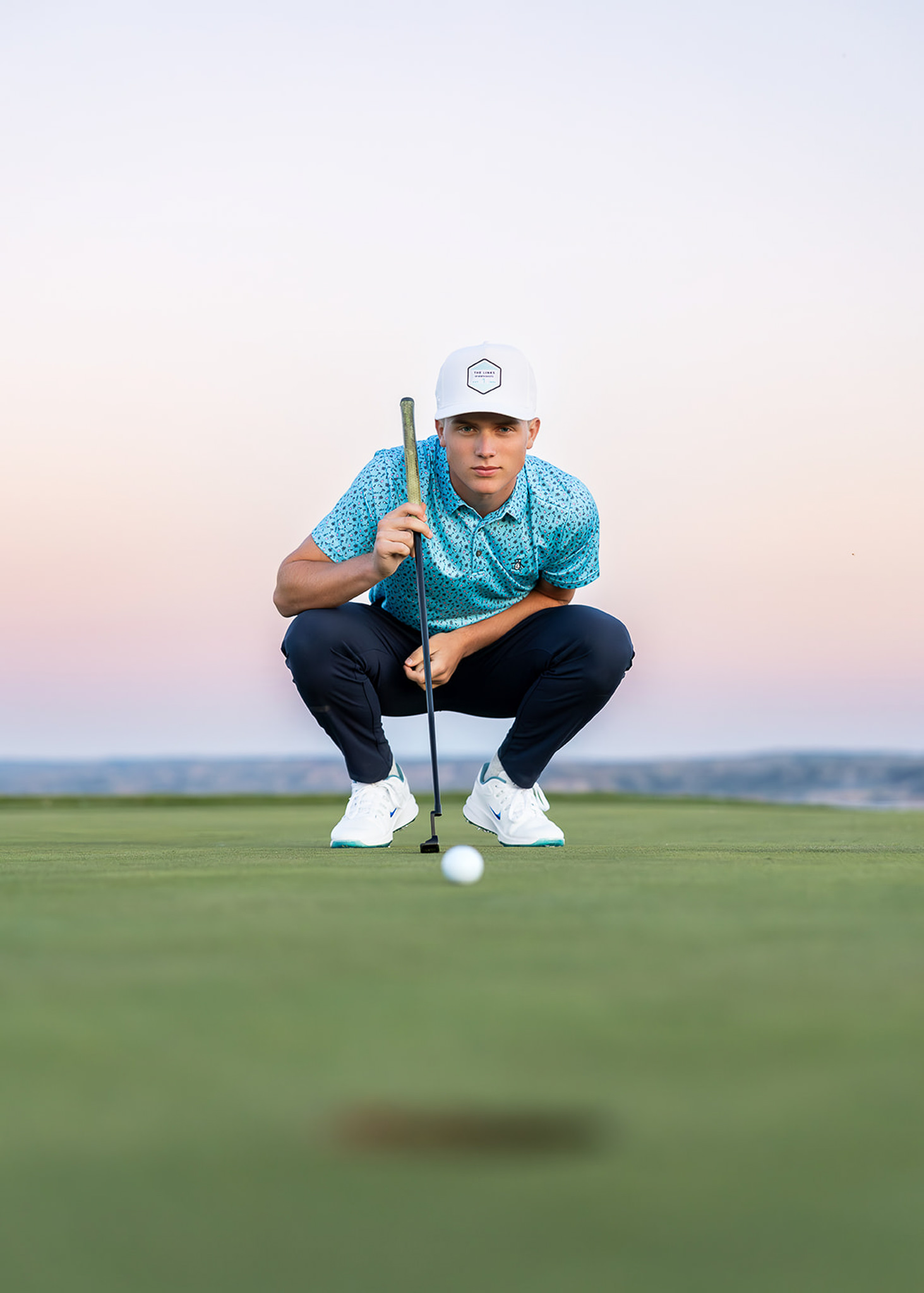 Senior boy at the Links golf course on the putting green