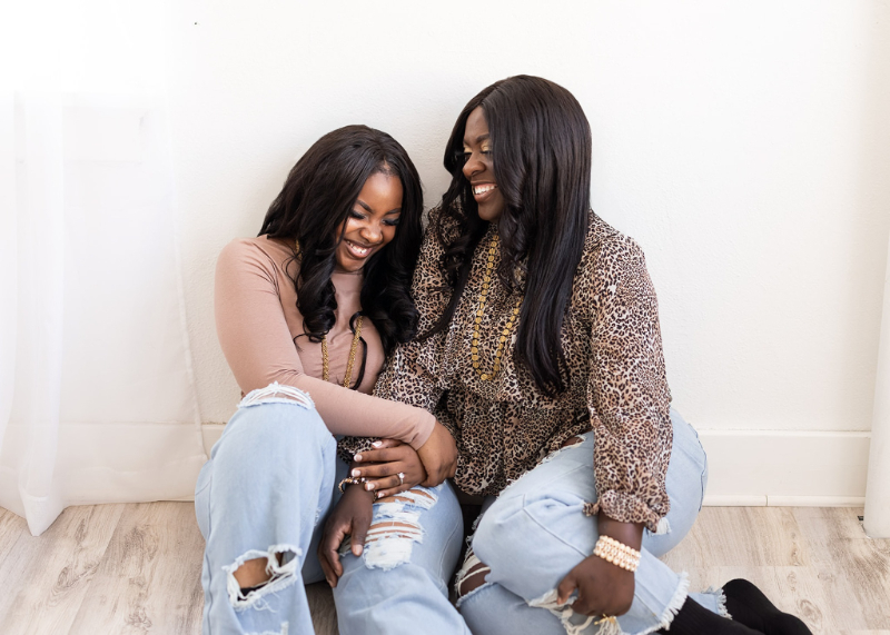 Senior and her mother laughing together during a relaxed portrait session celebrating their close relationship.